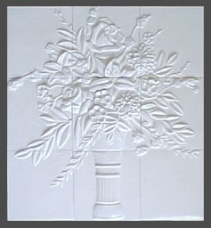 handmade nine panel ceramic tile mural with a high relief floral design and a one color glaze