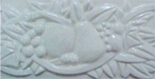 handmade ceramic tile with a high relief design and a one color glaze