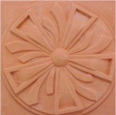 handmade terra cotta ceramic tile with a high relief design and a clear gloss or matte glaze
