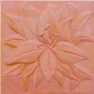 handmade terra cotta ceramic tile with a high relief flower design and a multi-colored glaze