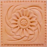 handmade terra cotta ceramic tile with a high relief design and a gloss or matte glaze