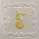 handmade ceramic tile with a high relief shell design and a multi-colored glaze