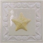 handmade ceramic tile with a high relief shell design and a multi-colored glaze