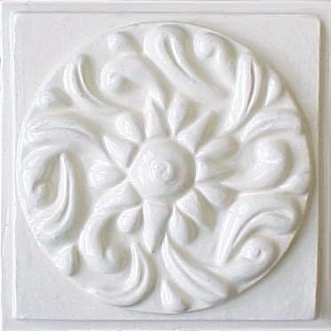 handmade ceramic tile with a high relief design and a one color glaze