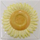 handmade ceramic tile with a high relief flower design and a multi-colored glaze