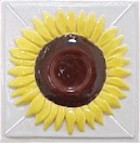 handmade ceramic tile with a high relief flower design and multiple glaze colors