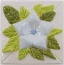 handmade ceramic tile with a high relief flower design and multiple glaze colors