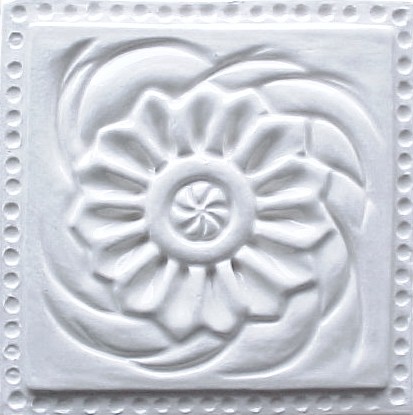 handmade ceramic tile with a high relief design and a one color glaze